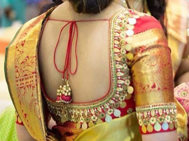 woaman wearing  back embroidery saree blouse